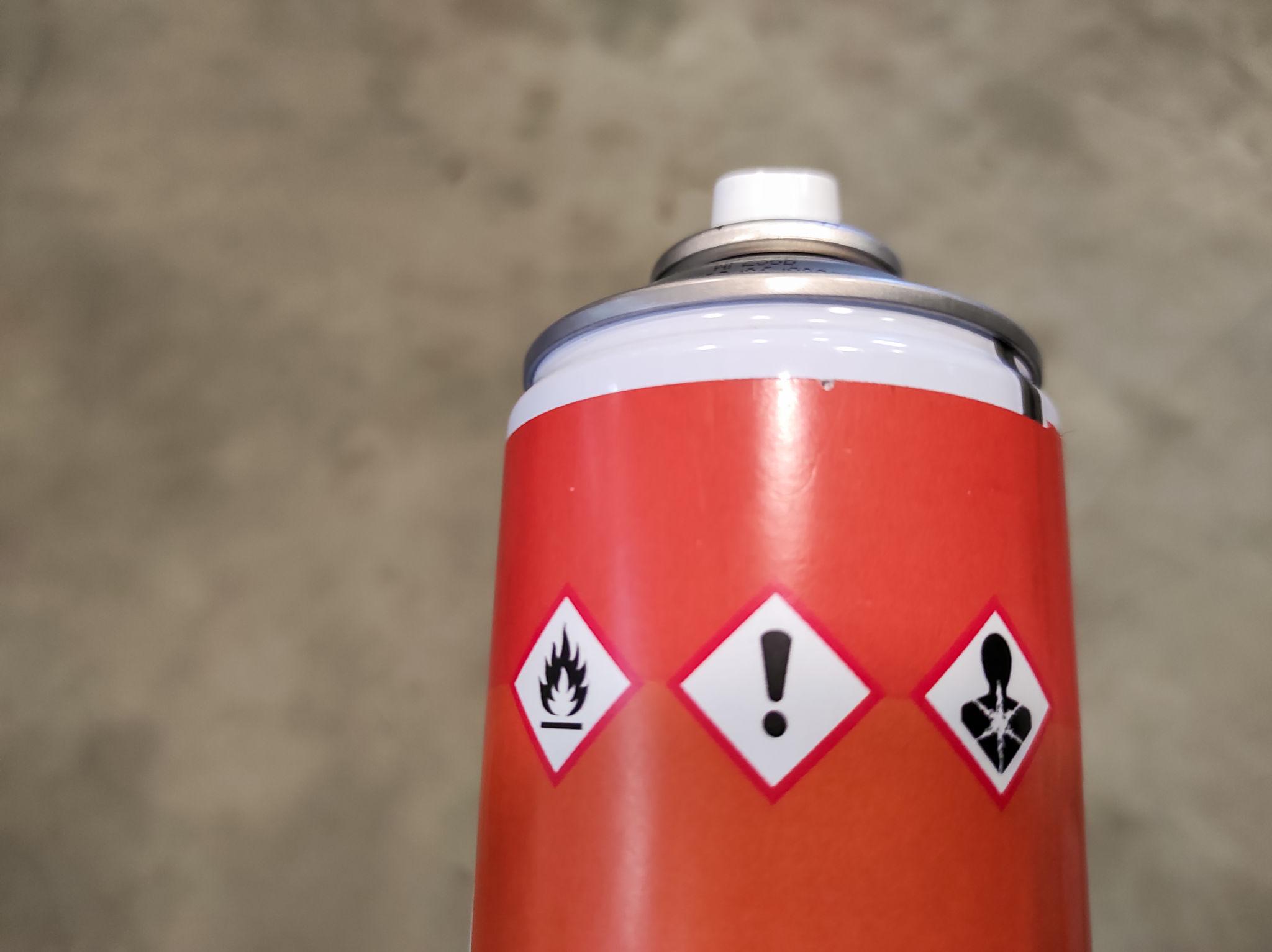 Hazardous waste containers with warning labels