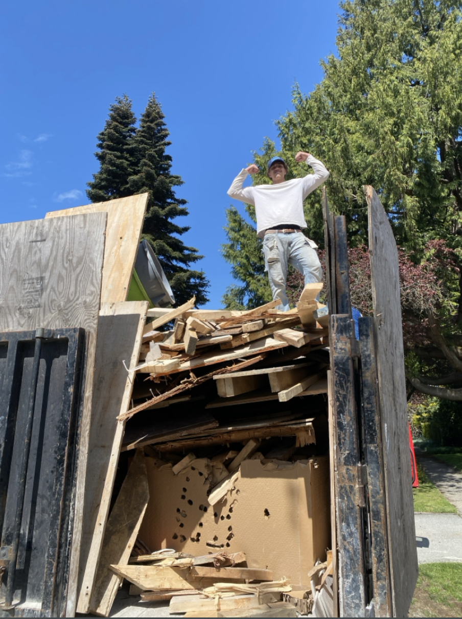 Go Junk Go crew member loading junk into bin - efficient waste removal in action